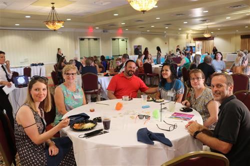 New teachers sit at table.
